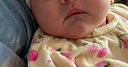 Octavia is registered to the contest to win money with this photo: baby, infant, child, sleepy, headband, bow, floral, clothing, soft, cozy, cute, portrait, closeup, person, apparel, fabric, indoors, newborn, resting, pink