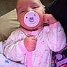 baby, pacifier, pink_onesie, elephant_print, blanket, infant, sleepy, cute, hand, person, indoor, carpet, cozy, resting, child, newborn, clothing, pattern, soft, comfort