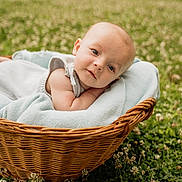 Halston is registered to the contest to win money with this photo: baby, basket, blanket, outdoor, grass, clover, flowers, infant, cute, portrait, nature, child, resting, soft, cozy, wicker, greenery, curious, summer, peaceful