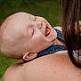 baby, child, smiling, laughing, face, head, shoulder, skin, person, closeup, happy, outdoor, denim, clothing, tattoo, parent, love, affection, joy, family