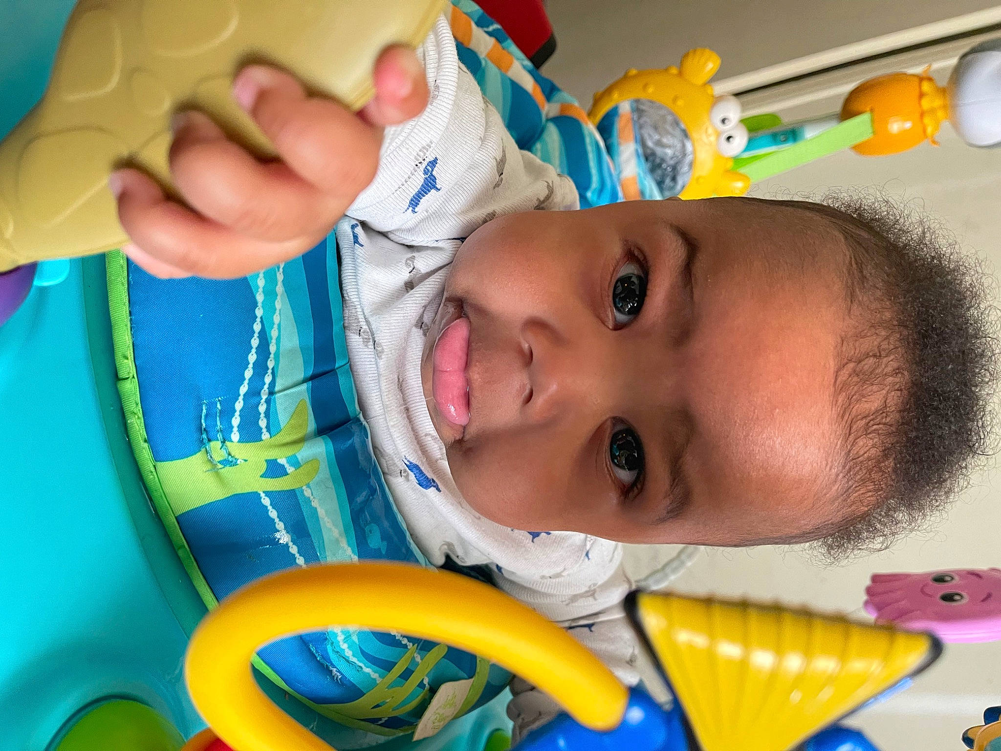 Denzel is registered to the contest to win money with this photo: baby, blue, cheek, chin, eye, eyebrow, face, finger, gesture, happy, head, iris, lip, mouth, nose, organ, person, product, skin, smile