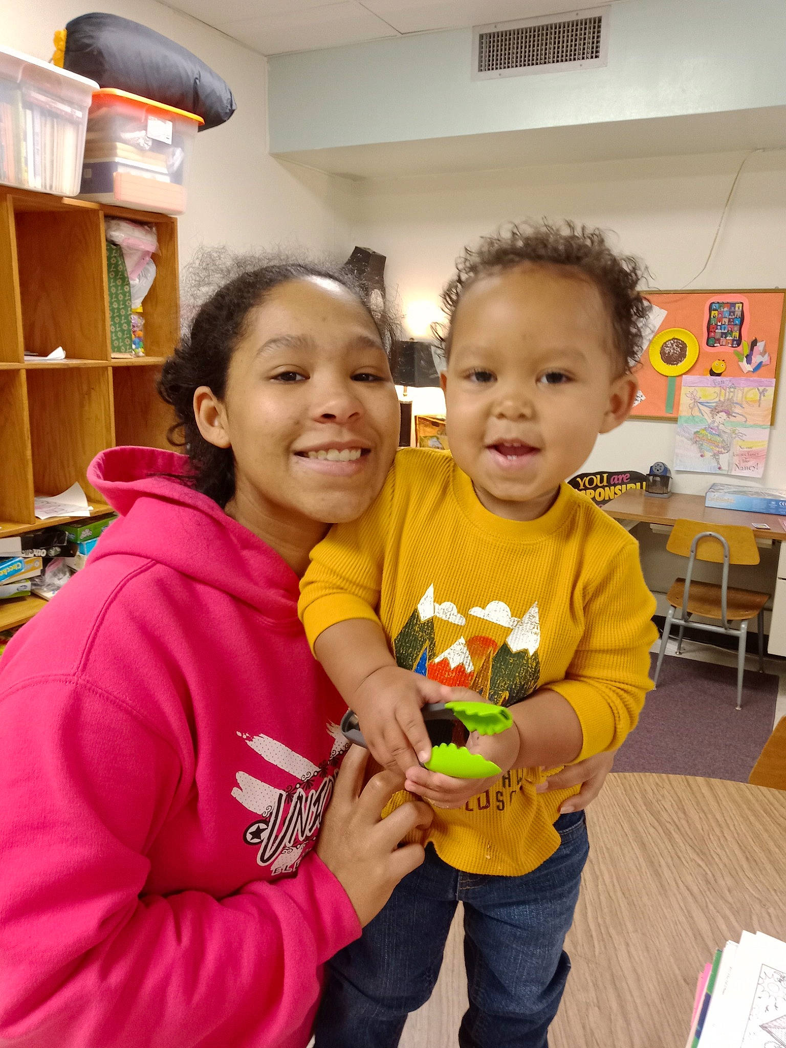 Ja'Marius is registered to the contest to win money with this photo: baby, chair, child, event, flooring, fun, happy, hoodie, joy, leisure, person, play, room, sharing, shelf, shelving, skin, smile, t_shirt, toddler