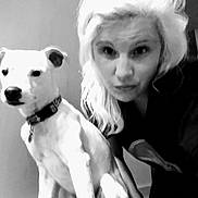 Lucki joined the competition — help win amazing prizes! woman, dog, pet, indoor, black_and_white, portrait, collar, light_hair, sitting, closeup, face, animal, human, expression, companion, furniture, wall, floor, monochrome, casual