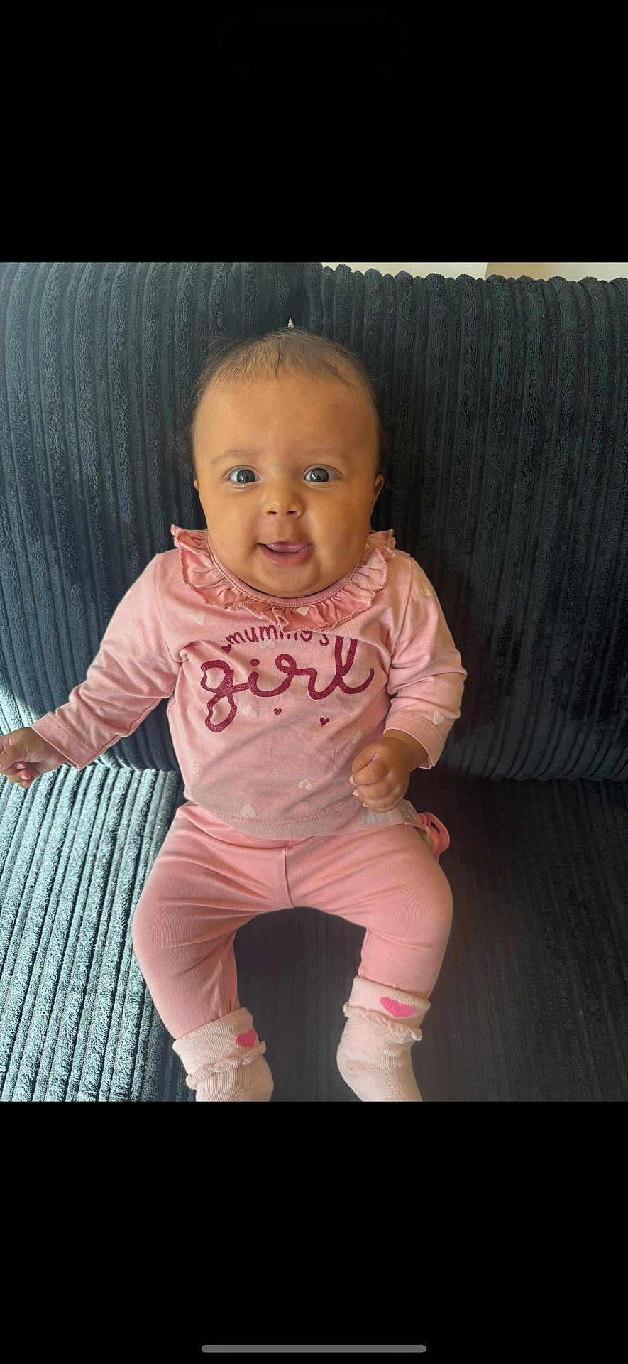 Naya joined the competition — help win amazing prizes! baby, child, girl, pink_clothing, sitting, couch, indoor, smile, face, eyes, socks, long_sleeve, pants, home, cute, infant, portrait, young_child, happy, texture