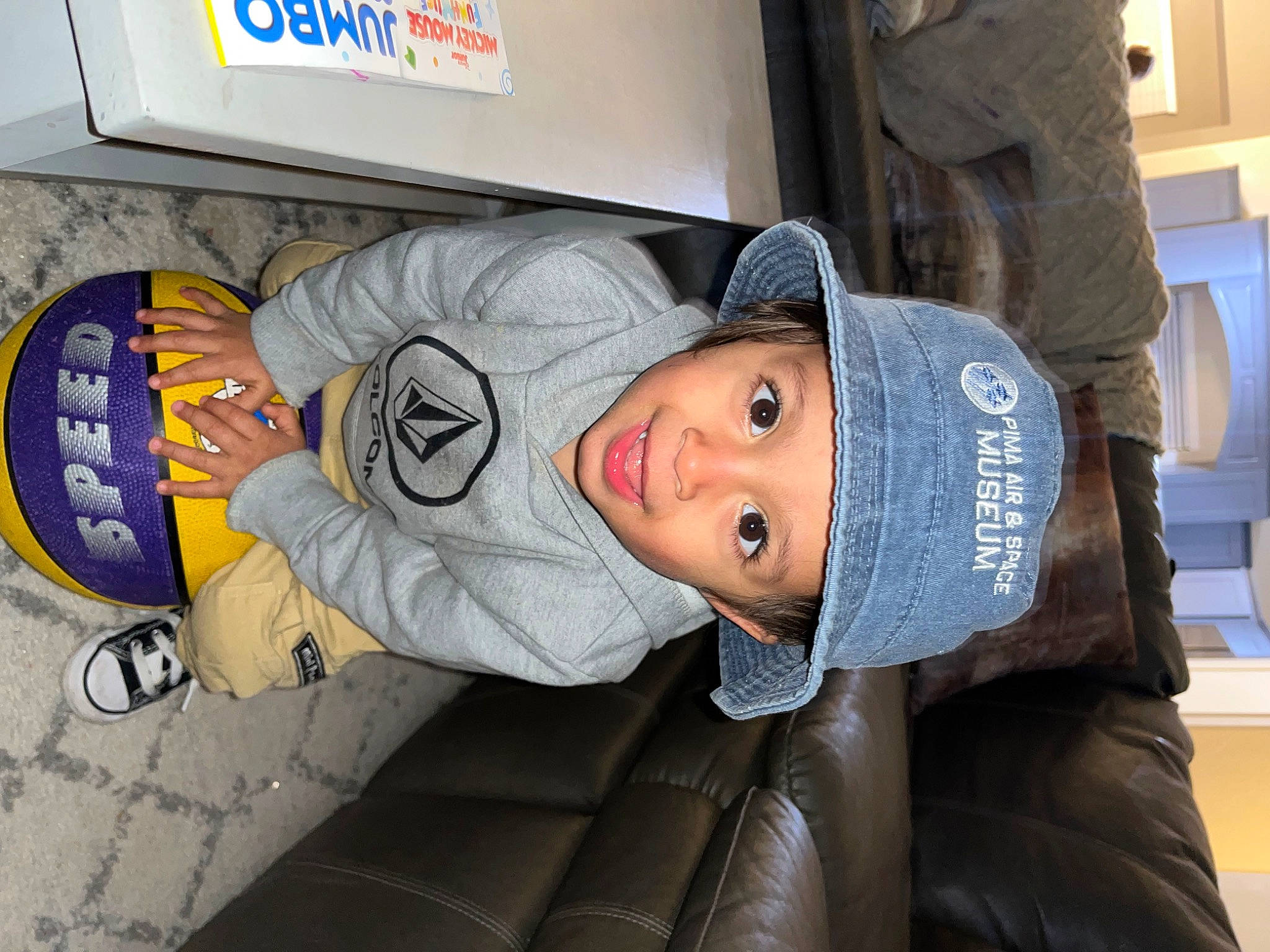 Apollo is registered to the contest to win money with this photo: aluminum_can, child, comfort, font, gas, headgear, headwear, logo, person, personal_protective_equipment, room, sports_gear, toddler