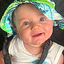 baby, child, smiling, face, hat, bucket_hat, blue_eyes, white_shirt, tropical_print, car_seat, harness, straps, infant, cute, happy, portrait, indoors, seatbelt, person, closeup