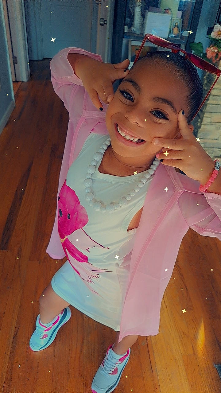 Christyanna is registered to the contest to win money with this photo: abdomen, bangs, black_hair, cabinetry, costume, door, fun, happy, human_leg, joy, leisure, long_hair, magenta, neck, person, pink, sandal, skin, smile, thigh