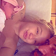 Serenity is registered to the contest to win money with this photo: baby, woman, man, beard, headband, sleeping, face, tattoo, nose_ring, bed, pillow, skin, closeup, family, indoor, people, portrait, relaxing, adult, child