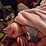 Serenity is registered to the contest to win money with this photo: baby, sleeping, blanket, pink, hand, face, infant, indoor, cozy, soft, leopard_print, bag, tattoo, person, clothing, relaxed, skin, portrait, resting, newborn