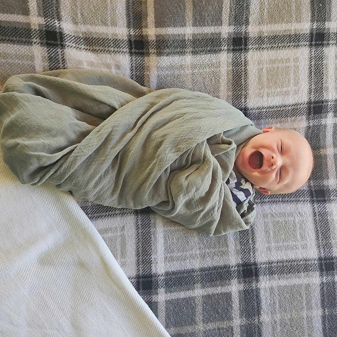 Landyn is registered to the contest to win money with this photo: baby, bed, bedroom, blanket, clothing, face, furniture, happy, head, homedecor, indoors, laughing, newborn, pants, person, photography, portrait, quilt, room, yawning