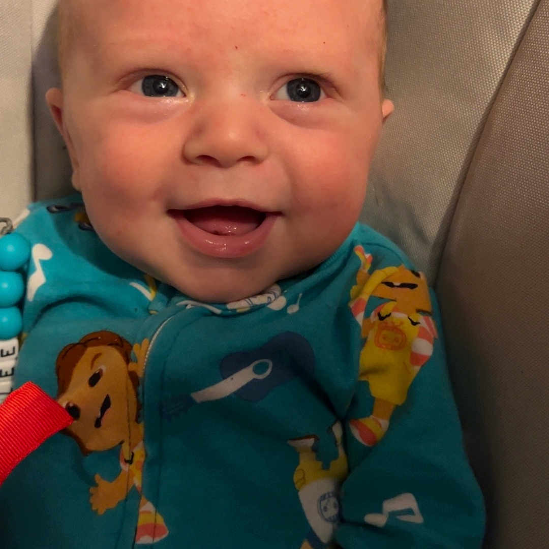 Bradlee joined the competition — help win amazing prizes! applique, baby, babylaughing, bodypart, clothing, cushion, face, happy, head, homedecor, laughing, mouth, newborn, pajamas, pattern, person, photography, portrait, smile, teeth