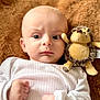 Denis participe au concours pour gagner de l'argent avec cette photo : baby, infant, white_clothing, plush_toy, hedgehog_toy, fist, blanket, soft_texture, cute, portrait, child, lying_down, close_up, indoors, young, face, expression, cuddly, warm, comfort