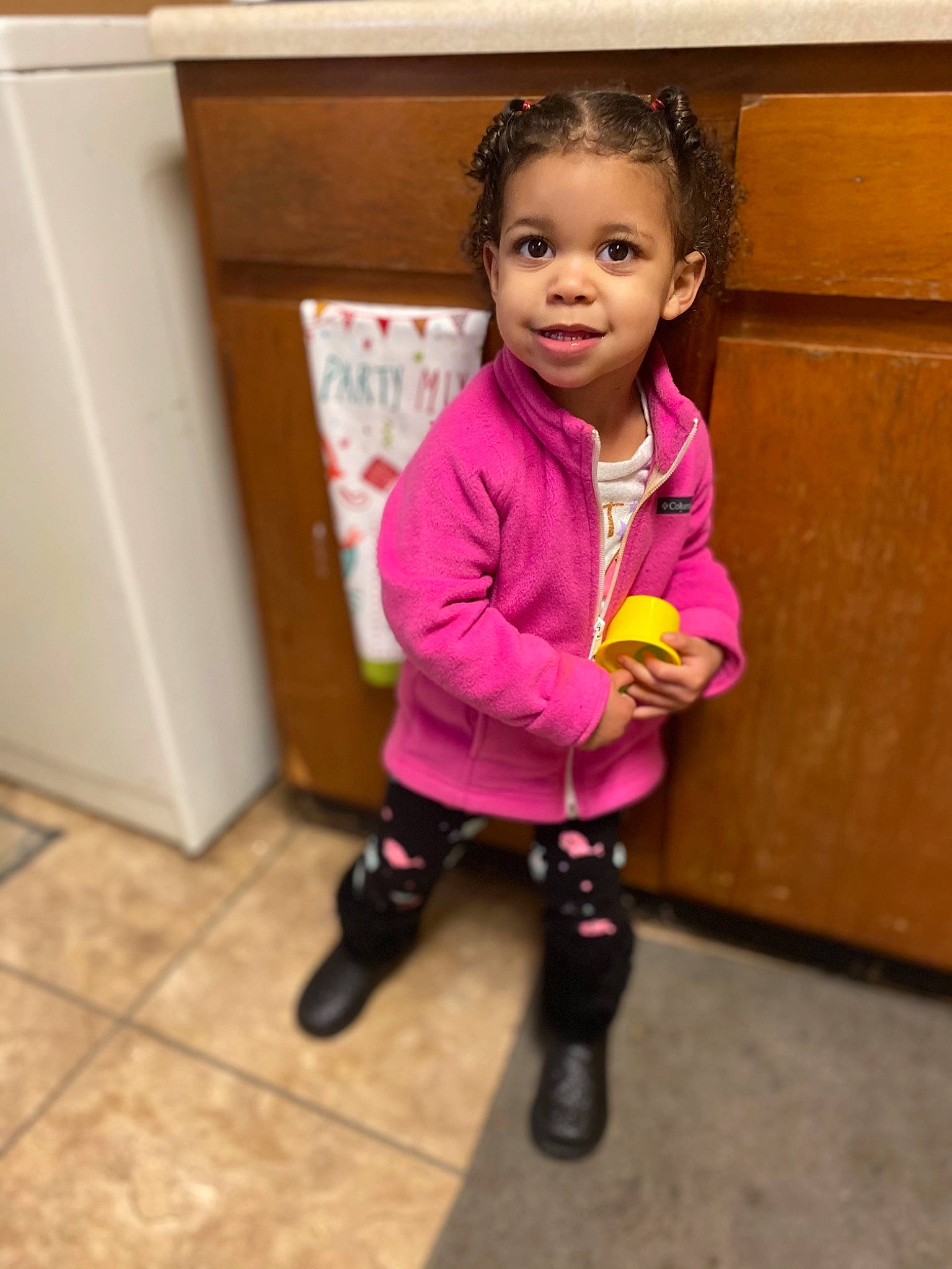 Maelynn is registered to the contest to win money with this photo: baby_toddler_clothing, child, door, dress, eye, happy, jacket, knee, magenta, outerwear, person, pink, purple, shoe, sleeve, smile, sneakers, sock, standing, toddler