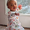 Rosalina joined the competition — help win amazing prizes! baby, child, pajamas, fruit_pattern, indoor, carpet, window, hand, curly_hair, expression, natural_light, soft_light, face, person, cute, infant, reaching, sitting, home, toddler