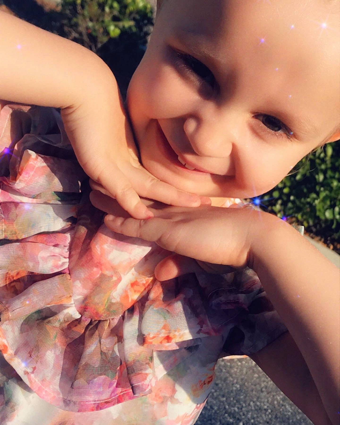 Madison is registered to the contest to win money with this photo: baby, baby_toddler_clothing, cuisine, dish, finger, fun, gesture, grass, happy, human, joy, meat, muscle, nail, peach, people_in_nature, person, pink, smile, thumb