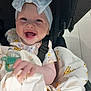 baby, smiling, headband, bow, blanket, giraffe_pattern, pacifier, stroller, infant, happy, cute, child, clothing, face, hand, indoors, person, seatbelt, fabric, portrait
