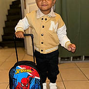 Myron a rejoint le concours — aidez-le/la à gagner de superbes lots ! toddler, child, boy, indoor, jacket, backpack, spiderman, white_shoes, tile_floor, stairs, door, smiling, standing, person, young_child, casual_clothing, portrait, handbag, small_boy, cute