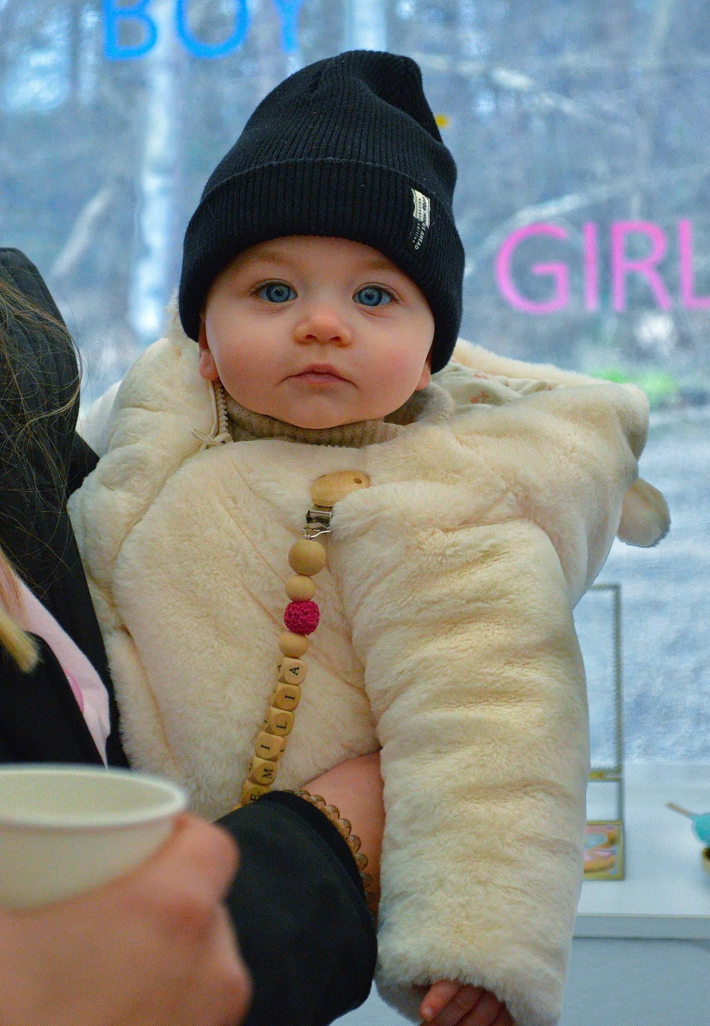 Emilia participe au concours pour gagner de l'argent avec cette photo : baby, beanie, cap, cheek, child, face, fashion_accessory, fun, fur, happy, headwear, jacket, jewellery, knit_cap, pattern, person, sitting, sleeve, toddler, winter