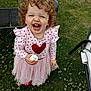 Harriet joined the competition — help win amazing prizes! child, toddler, curly_hair, pink_dress, heart_pattern, smiling, outdoor, grass, flowers, happy, food, snack, playful, garden, furniture, daylight, cute, person, fun, nature