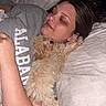Oliver Anthony joined the competition — help win amazing prizes! person, dog, bed, pillow, blanket, sleeping, cozy, indoor, relaxed, fur, cute, animal, pet, snuggling, gray_shirt, human_face, curly_hair, resting, comfort, closeup