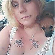 Mila joined the competition — help win amazing prizes! woman, dog, selfie, blonde_hair, lip_piercing, tattoo, dragonfly_tattoo, white_tank_top, lace, car_interior, seat, window, greenery, pet, small_dog, shoulder, necklace, portrait, casual, indoor