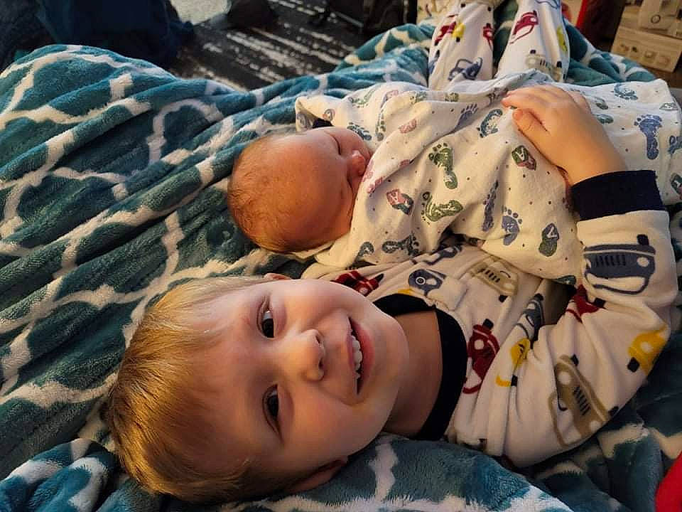 Jameson is registered to the contest to win money with this photo: baby, baby_toddler_clothing, bedtime, cheek, child, comfort, fun, happy, head, joy, linens, mouth, person, room, sitting, skin, smile, textile, toddler, tree