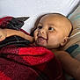 Kyire joined the competition — help win amazing prizes! arm, baby, black, blanket, child, comfort, cozy, cute, expression, face, happy, head, indoors, infant, pillow, portrait, red, skin, smiling, young