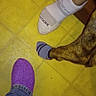 Oso is registered to the contest to win money with this photo: dog, canine, sock, socks, paws, legs, feet, purple_sock, white_sock, floor, tile_floor, indoor, pet, animal, closeup, overhead_view, brown_fur, white_fur, casual, funny