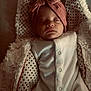 baby, sleeping, infant, blanket, polka_dot, headband, bow, soft_fabric, cute, peaceful, indoors, child, newborn, cozy, white_clothing, portrait, closeup, face, resting, warm_lighting