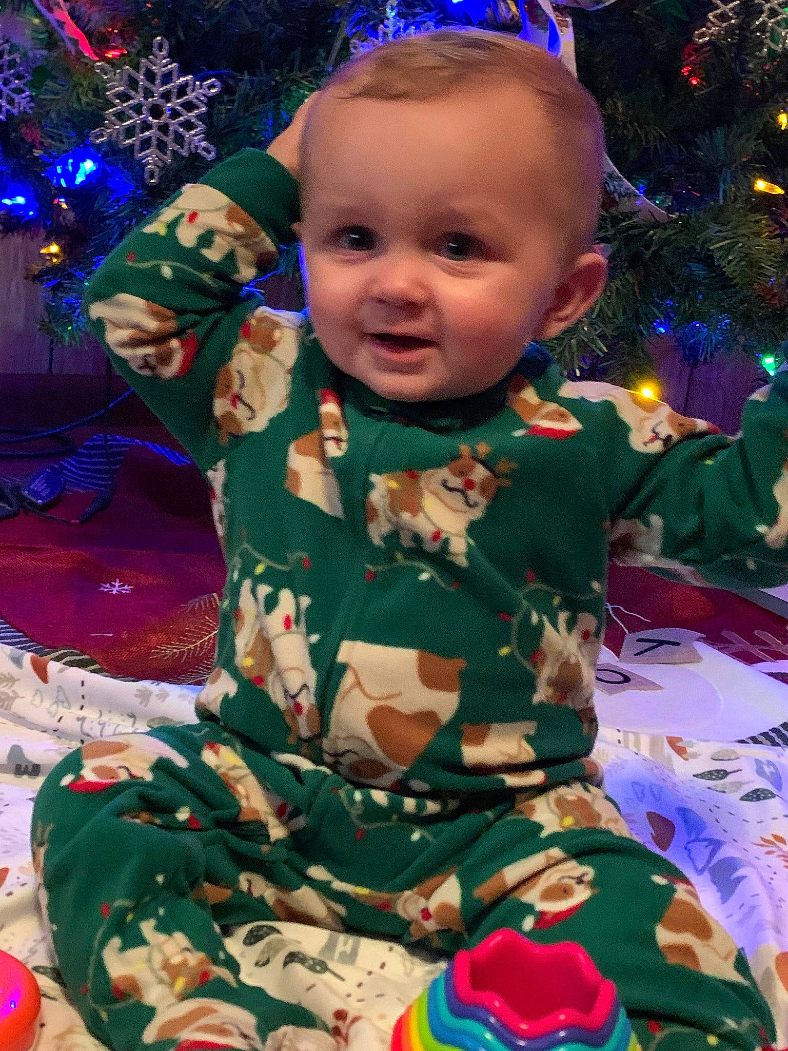 Kanaan is registered to the contest to win money with this photo: baby, baby_toddler_clothing, blue, cheek, child, christmas_decoration, christmas_ornament, christmas_tree, event, fun, happy, head, holiday, holiday_ornament, human_body, light, ornament, person, sleeve, toddler