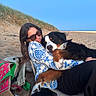 woman, person, dog, dogs, berner, bernese_mountain_dog, fluffy, pet, animal, cuddle, hugging, smiling, sunglasses, beach, sand, sand_dunes, ocean, blue_sky, outdoors, vacation
