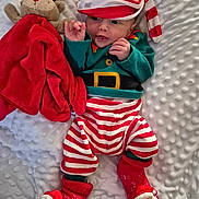 Elijah joined the competition — help win amazing prizes! baby, infant, child, christmas_outfit, striped_clothing, hat, plush_toy, reindeer, blanket, red, white, green, christmas_theme, smiling, cute, lying_down, socks, soft_texture, holiday, festive