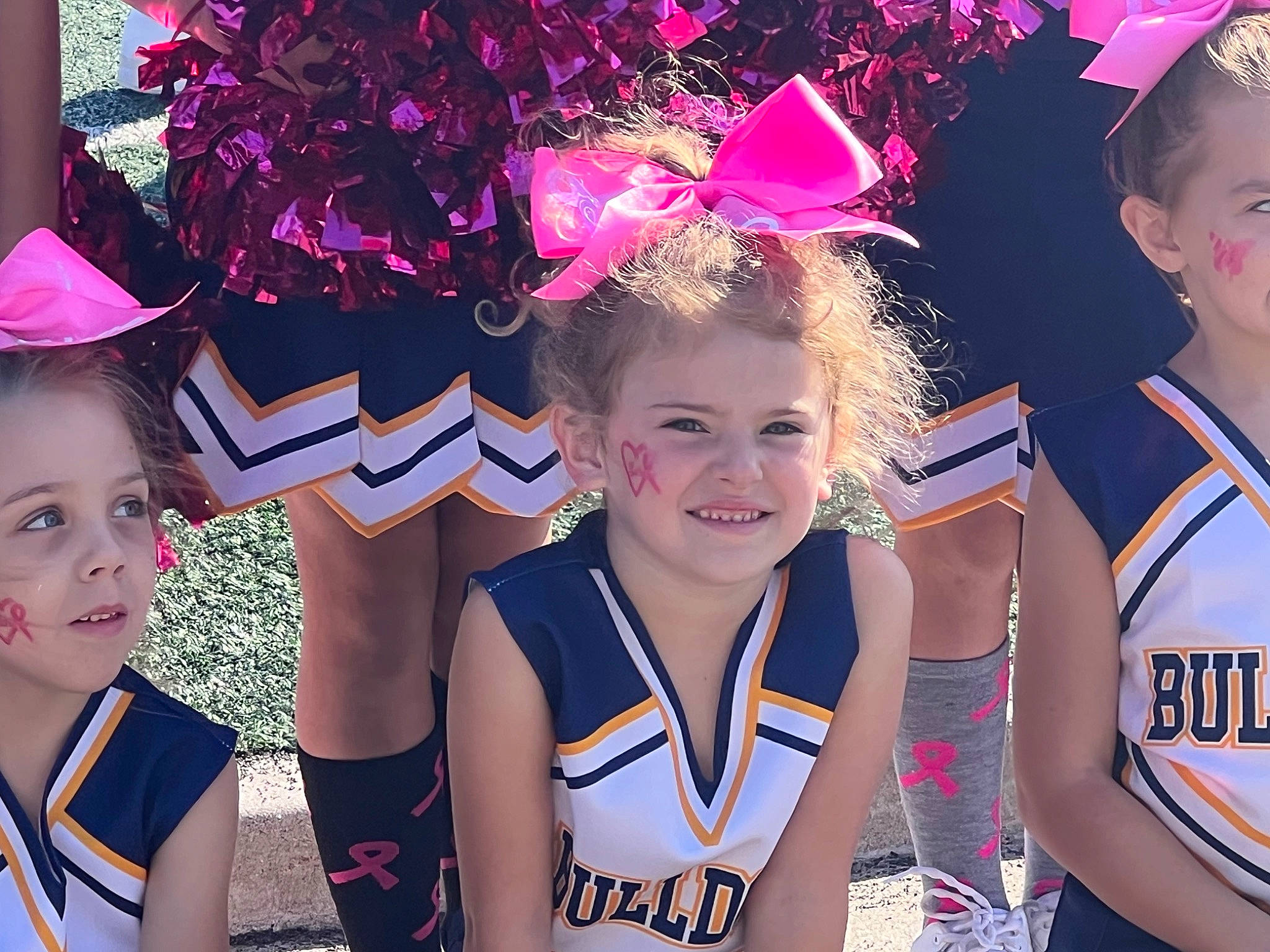 Giavonna is registered to the contest to win money with this photo: cheerleading, cheerleading_uniform, competition_event, costume_hat, electric_blue, event, fashion_accessory, fun, happy, headgear, jersey, joy, person, smile, sports, sports_uniform, t_shirt, team, team_sport, toddler