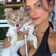 Kiki joined the competition — help win amazing prizes! woman, dog, pet, smile, outdoor, furniture, leash, black_dress, necklace, earrings, watch, happy, tongue_out, fur, face, hair, green_turf, couch, table, selfie