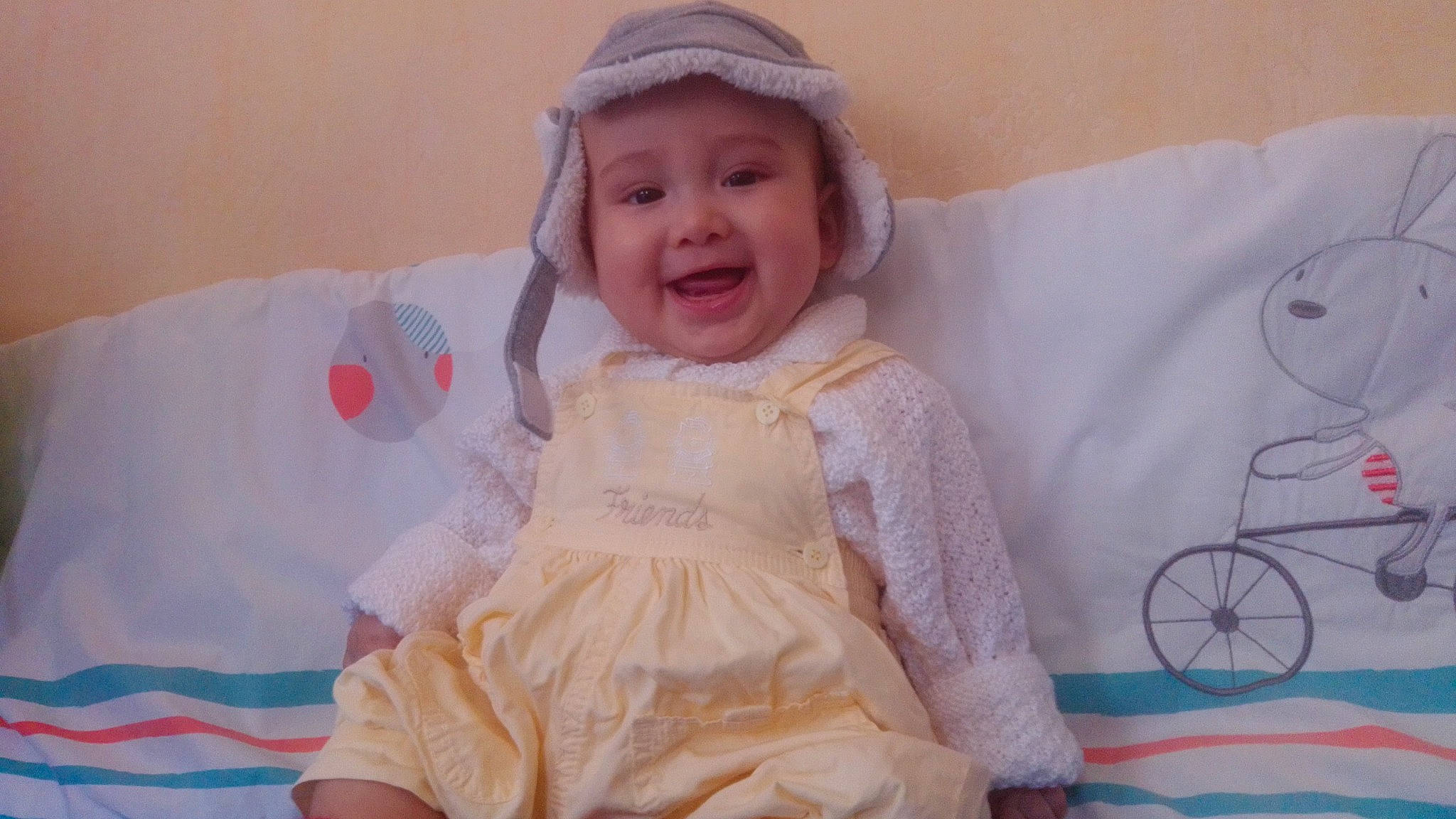 Lima participe au concours pour gagner de l'argent avec cette photo : baby, baby_toddler_clothing, blond, cheek, child, day_dress, dress, embellishment, happy, headwear, iris, joy, linens, pattern, person, pink, ruffle, skin, sleeve, smile