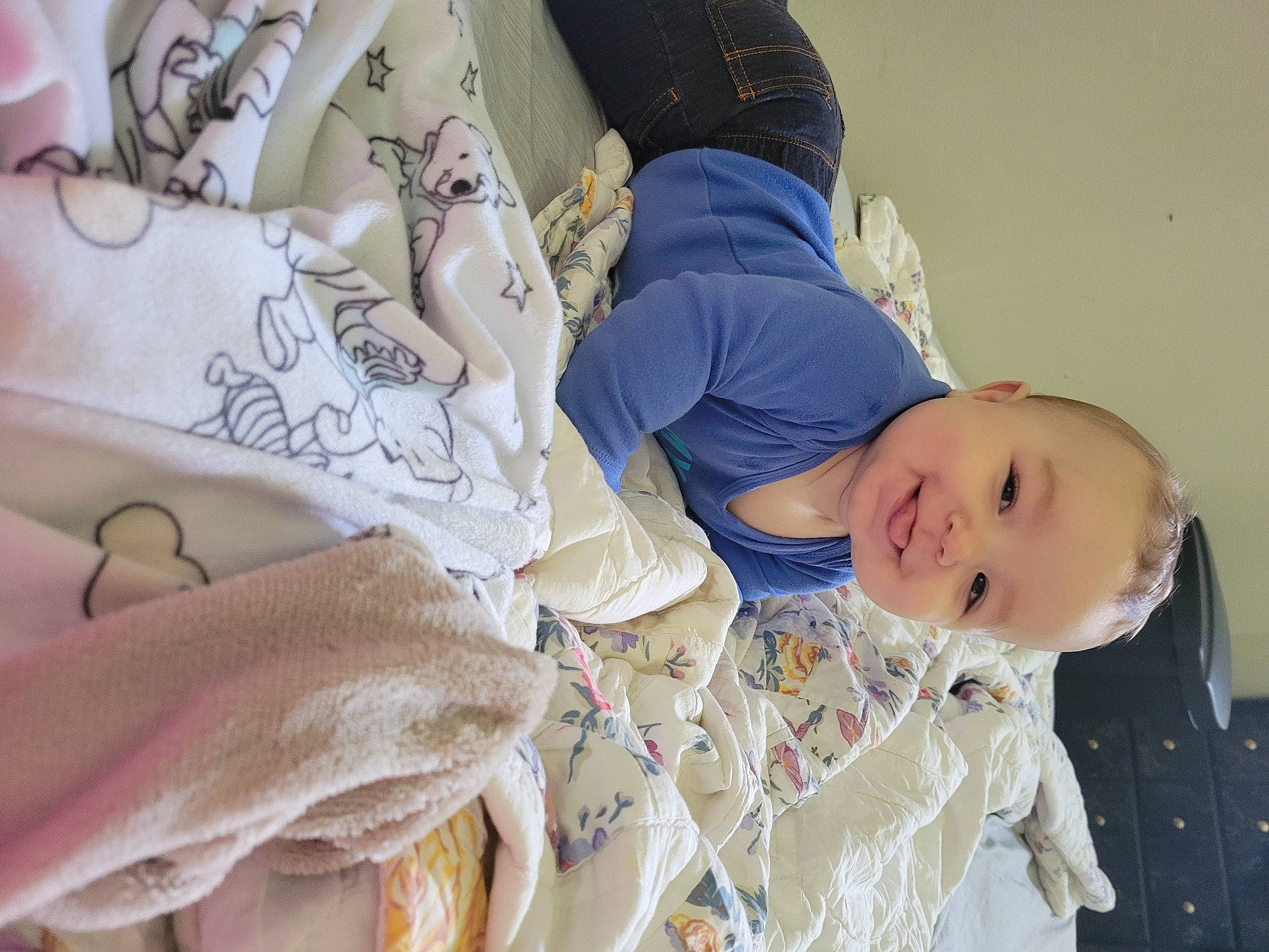 Adrien is registered to the contest to win money with this photo: baby, baby_products, baby_toddler_clothing, child, comfort, happy, hat, head, human_body, joy, linens, pattern, peach, person, product, room, sitting, skin, sleeve, smile
