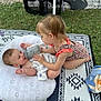 Bryson is registered to the contest to win money with this photo: baby, toddler, child, bottle, blanket, swimsuit, grass, outdoor, mat, feeding, smiling, playing, cute, family, summer, baby_boy, girl, toy, relaxing, nature