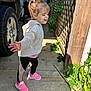 Gabriella joined the competition — help win amazing prizes! child, girl, hoodie, pink_sneakers, black_leggings, concrete, outdoor, daylight, vehicle, tire, wooden_lattice, plants, greenery, shadow, side_profile, smiling, casual_clothing, playful, sunlight, pony_tail