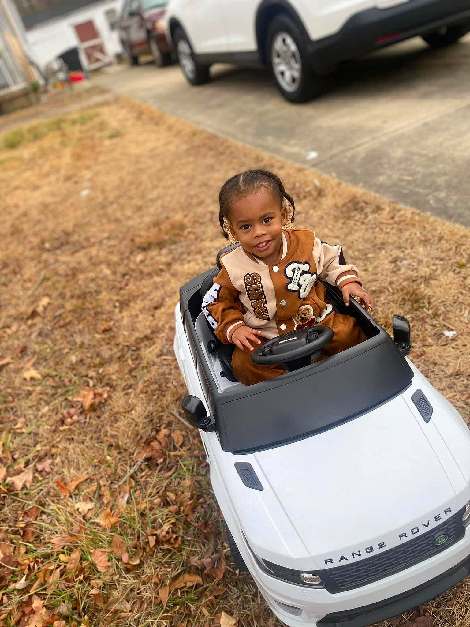 Jacob Scales Jr. is registered to the contest to win money with this photo: auto_part, automotive_design, automotive_exterior, automotive_lighting, automotive_tire, automotive_wheel_system, bumper, car, fender, hood, motor_vehicle, person, personal_luxury_car, rim, smile, t_shirt, tire, toddler, vehicle, vehicle_door