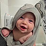 Xavier joined the competition — help win amazing prizes! baby, smiling, towel, hooded_towel, cute, infant, face, blue_eyes, happy, skin, child, portrait, indoors, hand, soft_texture, cozy, expression, close_up, adorable, person