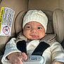Adrián joined the competition — help win amazing prizes! baby, infant, car_seat, seatbelt, white_hat, knit_hat, white_sweater, smile, hand, sensor_safe, child, cute, cozy, straps, indoor, face, person, safety, car_seat_warning_label, closeup