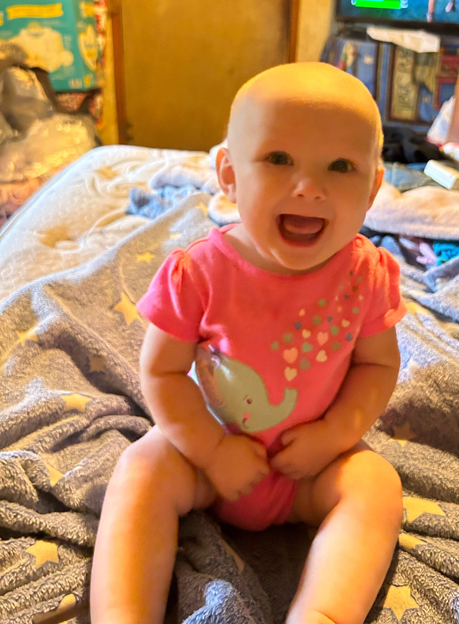 Paisley is registered to the contest to win money with this photo: baby, baby_toddler_clothing, cheek, child, eye, facial_expression, flooring, fun, happy, human_leg, iris, mouth, person, pink, sitting, skin, smile, thigh, toddler, vacation