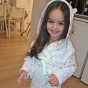 Elena a rejoint le concours — aidez-le/la à gagner de superbes lots ! child, girl, smiling, robe, hood, indoor, kitchen, wooden_floor, furniture, cabinet, appliance, long_hair, happy, person, home, cozy, cute, young, polka_dot, standing