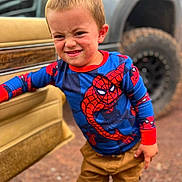 Paul joined the competition — help win amazing prizes! child, boy, spiderman_shirt, face, mud, car_door, vehicle, tire, outdoor, pants, expression, standing, playful, dirt, casual_clothing, portrait, young, person, fun, grit