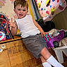 Paul joined the competition — help win amazing prizes! child, boy, white_tank_top, gray_shorts, toy_car, purple_toy, wooden_chest, quilt, cupcake_pattern, backpack, superhero, playroom, carpet, playful, smiling, indoor, furniture, cute, sitting, happy