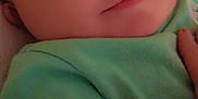 Blake joined the competition — help win amazing prizes! baby, close_up, face, hand, green_shirt, infant, calm, soft_lighting, skin, portrait, child, young, cute, resting, indoors, person, human, tender, young_child, cozy
