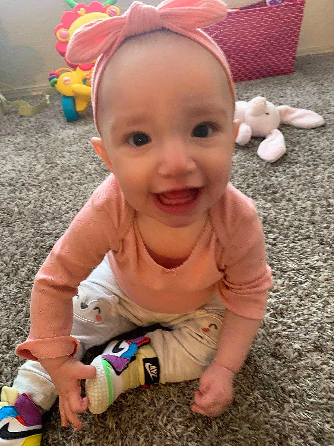 Elianna is registered to the contest to win money with this photo: baby, baby_laughing, baby_toddler_clothing, cap, child, face, finger, flooring, foot, fun, grass, happy, people_in_nature, person, photograph, play, skin, smile, thumb, toddler