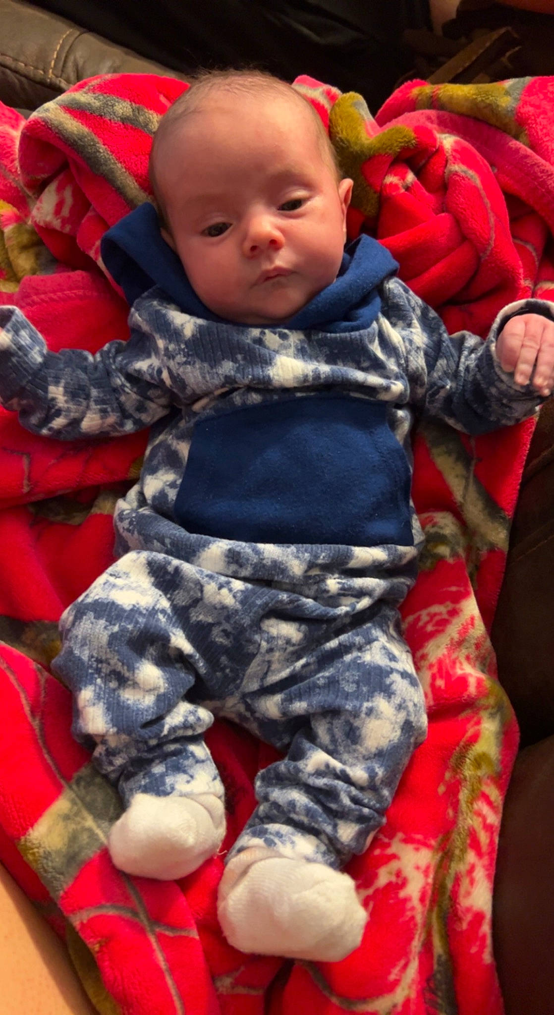 Shelby is registered to the contest to win money with this photo: baby, baby_toddler_clothing, camouflage, cheek, child, comfort, facial_expression, fun, gesture, grass, happy, military_camouflage, pattern, person, photograph, red, sitting, sleeve, snapshot, textile