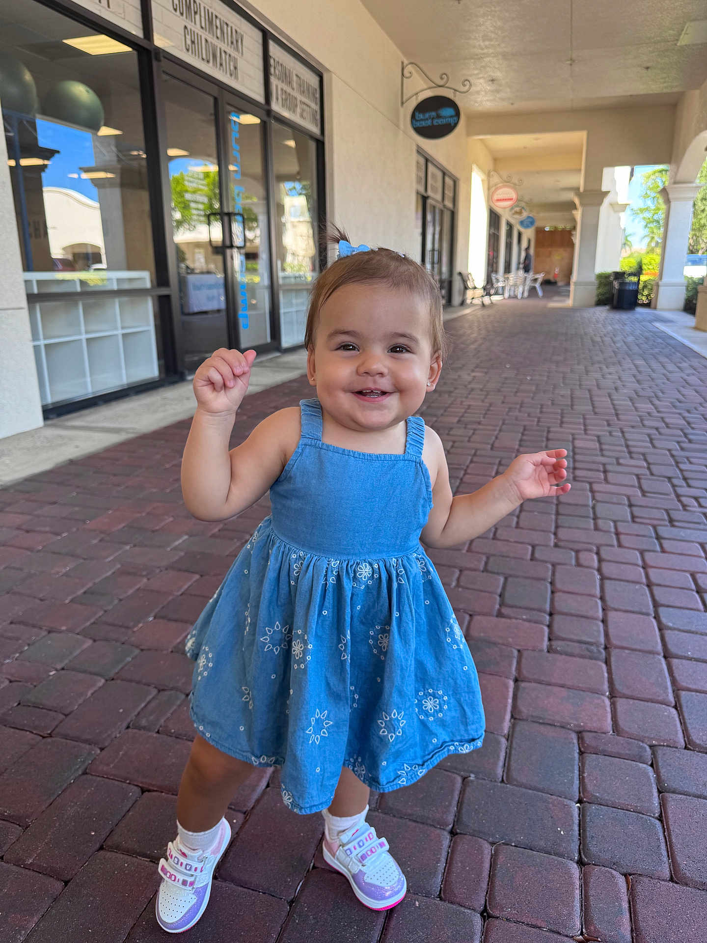 Ashley joined the competition — help win amazing prizes! toddler, child, smiling, blue_dress, sneakers, outdoor, brick_walkway, shopping_center, happy, person, sunny, daylight, casual_clothing, young_child, cute, walking, small_hair_tie, footwear, playful, portrait