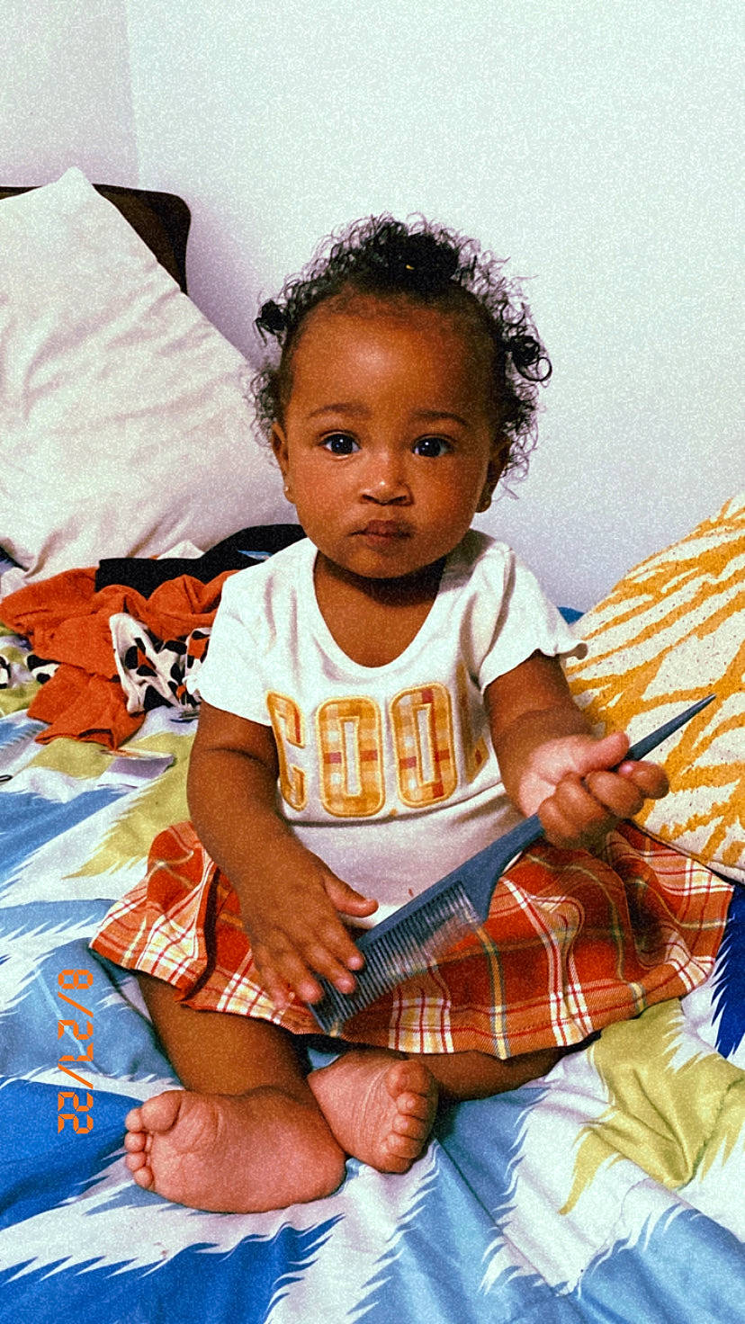 Asiyah is registered to the contest to win money with this photo: baby, baby_toddler_clothing, cheek, child, comfort, fun, happy, human_leg, iris, linens, pattern, person, plaid, shorts, sitting, skin, sleeve, sock, t_shirt, tartan